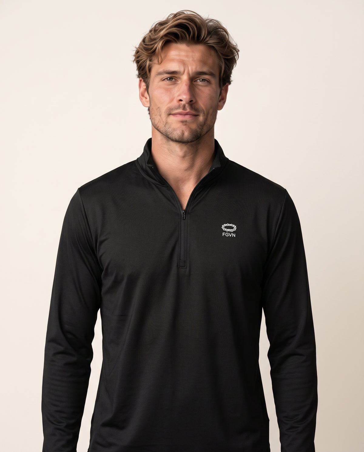 Alex wears a black quarter-zip in a front-facing photograph.