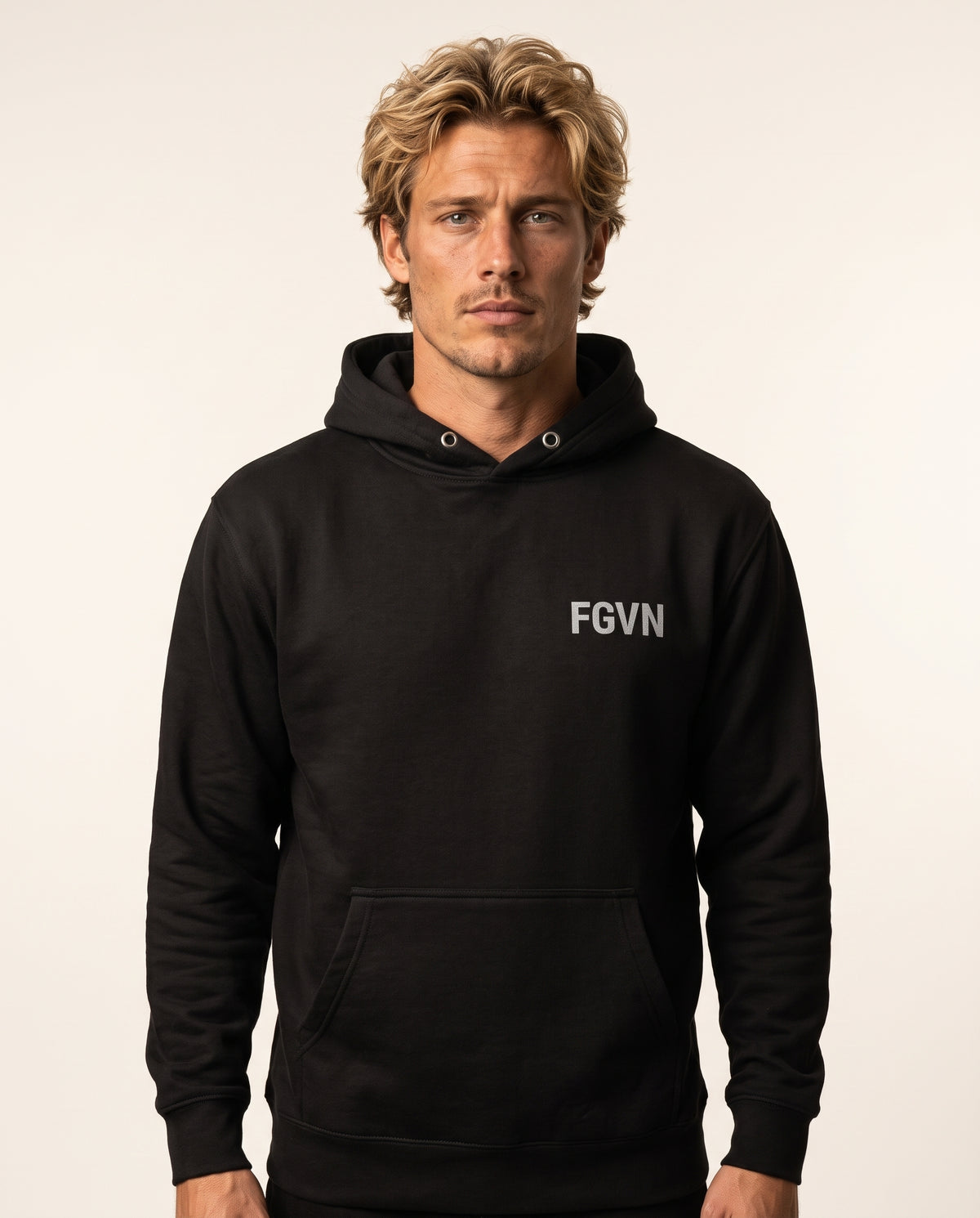 Caleb wears a black hoodie in a front-facing photograph.